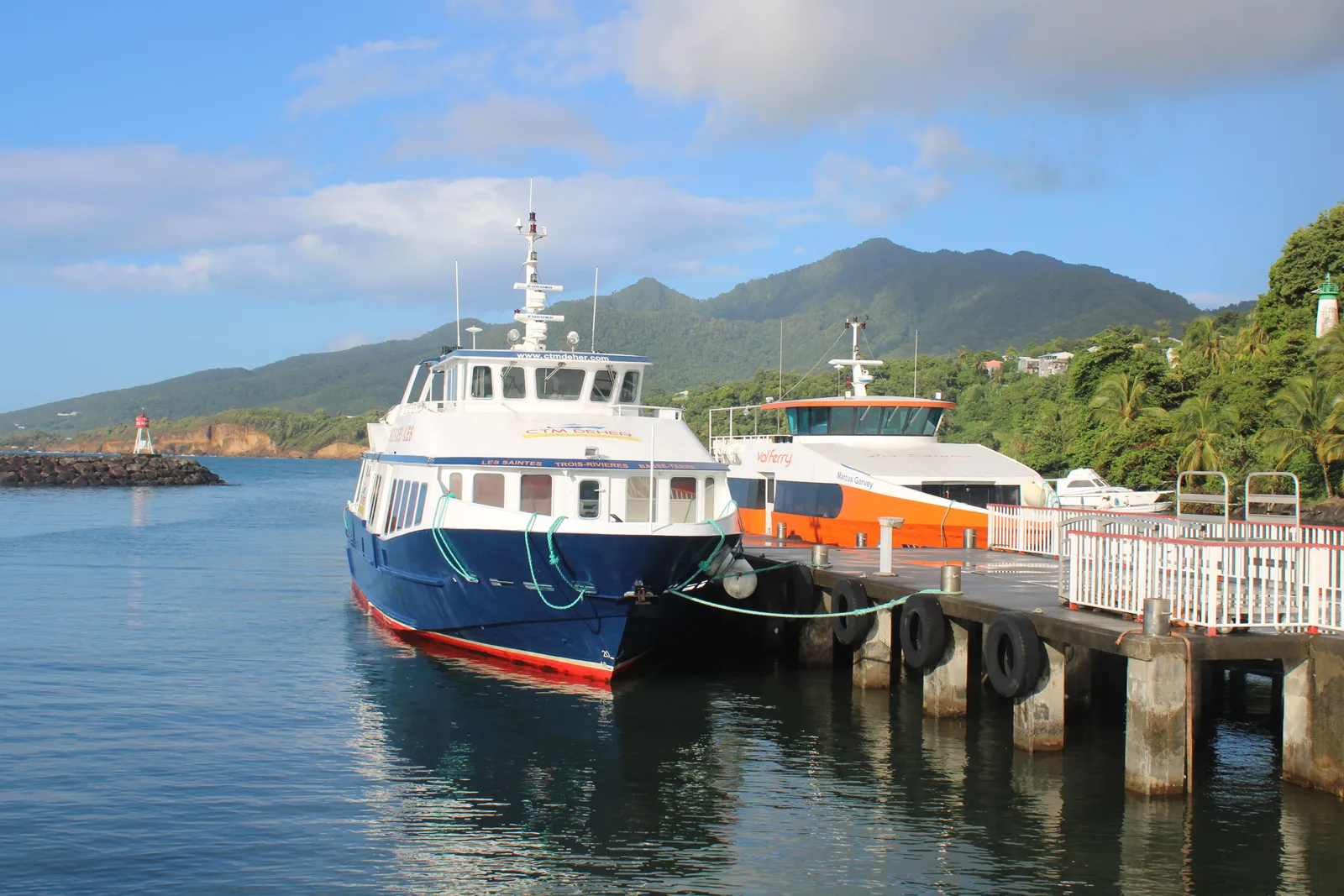 Roseau harbour, Dominica — ferry boats moored against the lush mountain backdrop of the capital, where new citizens by investment will now arrive to collect their passports.